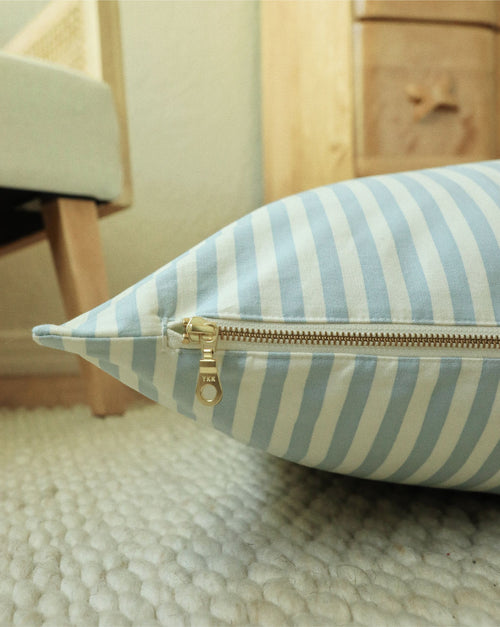 Blue striped dog bed with plush cushioning, perfect for small to medium-sized dogs.