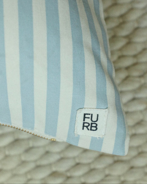 Detailed close-up of blue striped dog bed fabric and stitching quality.