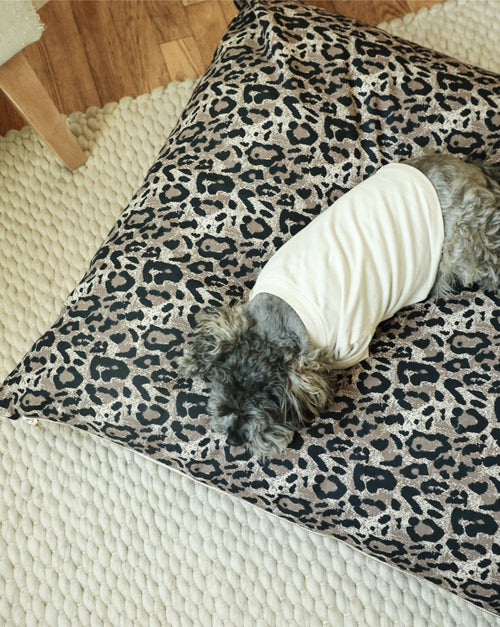 Cozy round dog bed with luxurious leopard print, perfect for small to medium dogs.