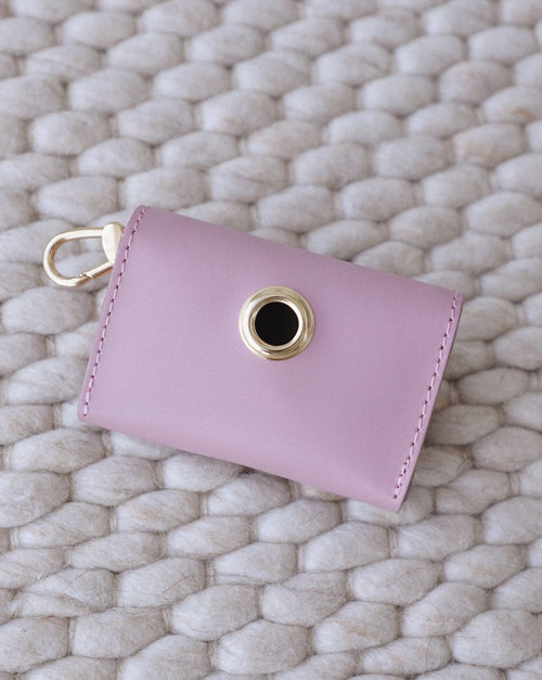 Stylish mauve leather dog waste bag holder, secure closure, convenient for owners