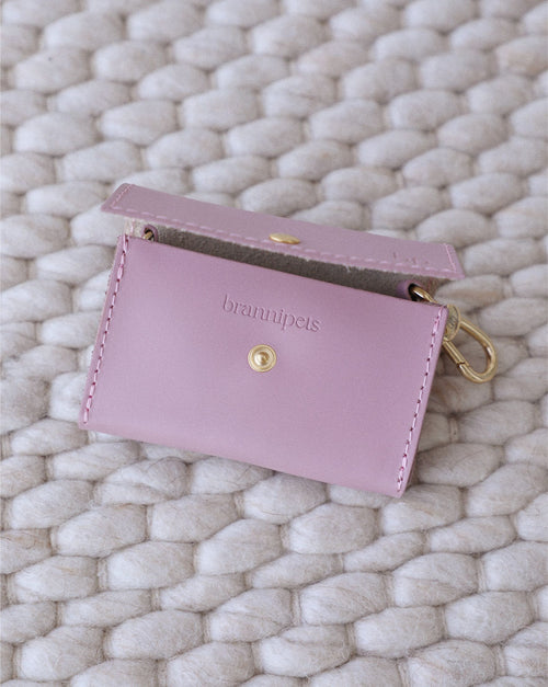 Side view of mauve leather dog waste bag holder, durable and chic design