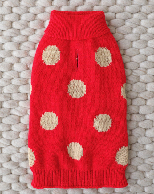 Red reversible dog sweater with festive jingle bell design.