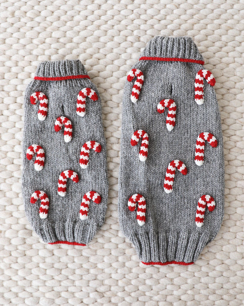 Holiday-themed red and white dog sweater in knit pattern.