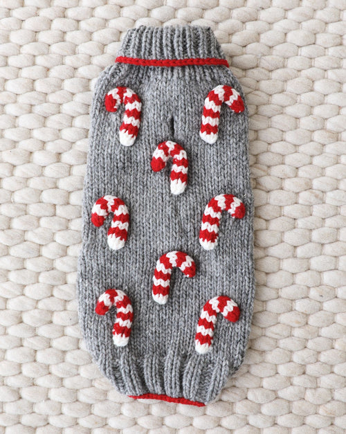 Red and white striped knit dog sweater for holiday festivities.