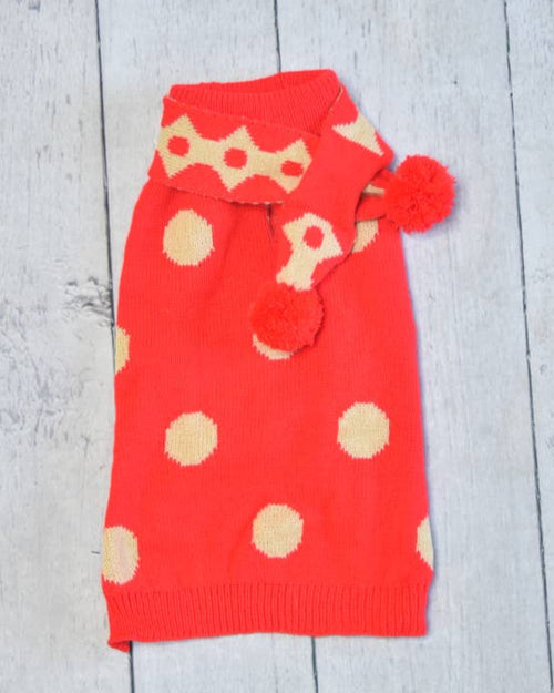 Small dog wearing reversible holiday scarf, soft knit for winter warmth.