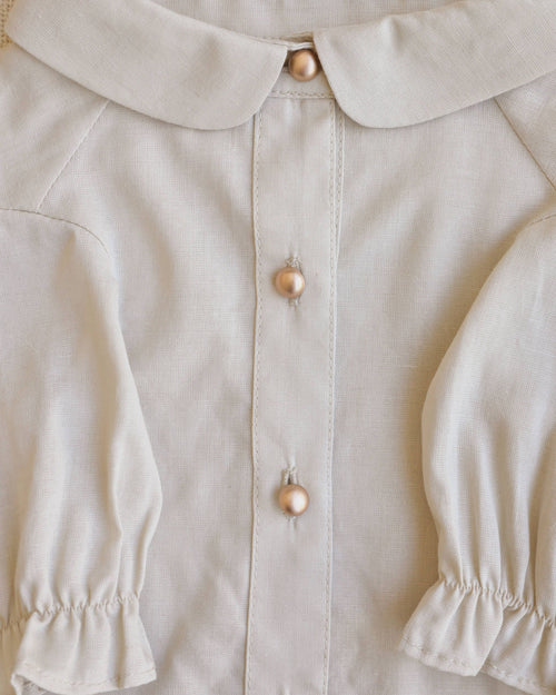 Close-up of Mon Petit Oatmeal Linen Dog Blouse, perfect for toy poodles and other small dog breeds.