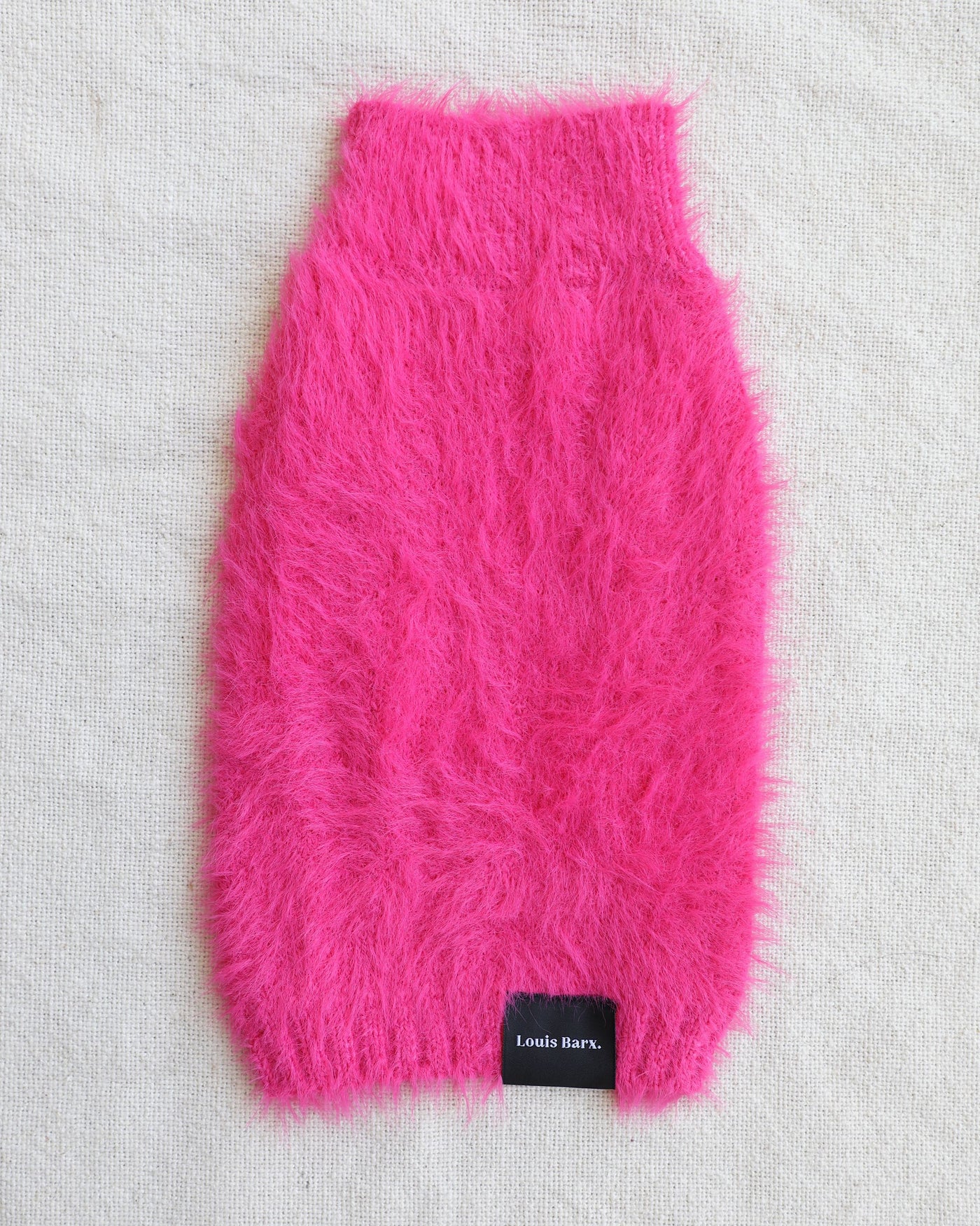 Fluffy hot pink dog sweater on white background