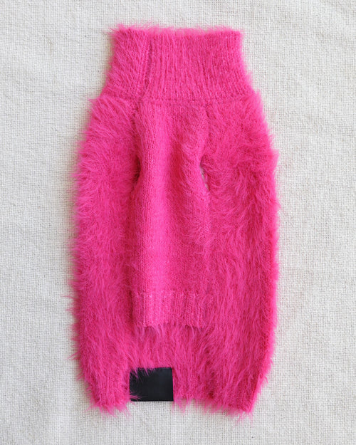 Fluffy hot pink dog sweater on white background. Corgi pink sweater.