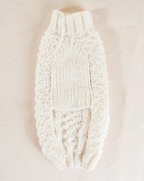 Natural colored cable-knit dog sweater, perfect for layering on colder days