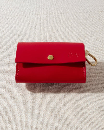 red leather dog poop bag holder with gold accents
