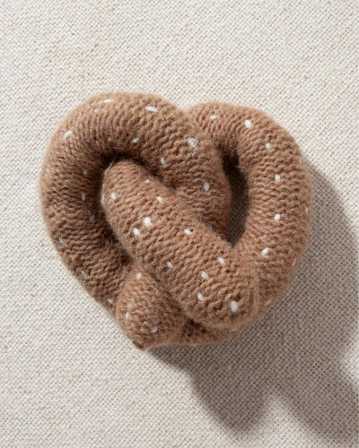 tan and white hand knit crochet pretzel dog toy