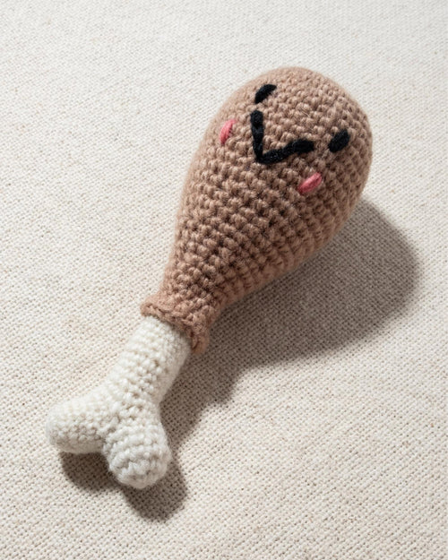 hand knit chicken drumstick dog toy with smiley face