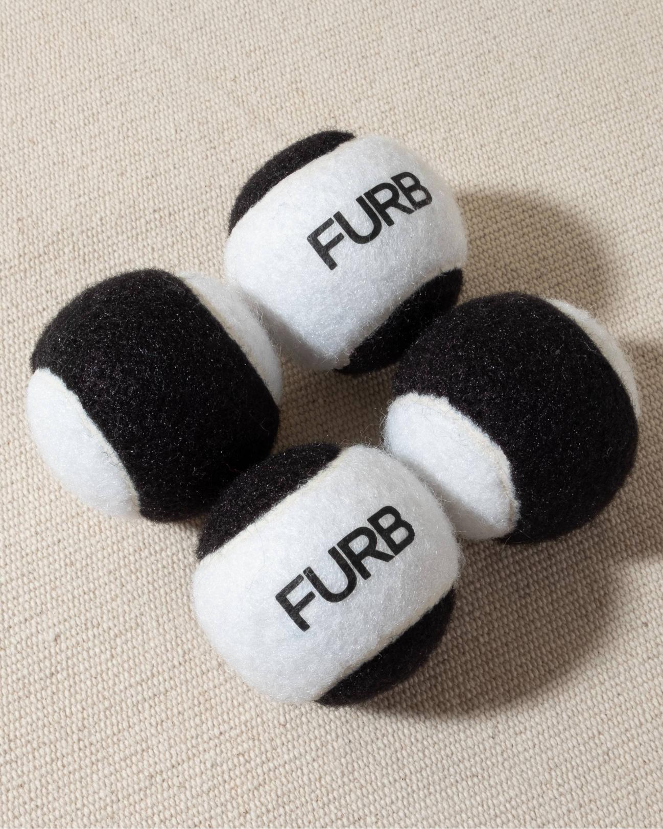 FURB branded black and white tennis ball with black furb logo for dogs