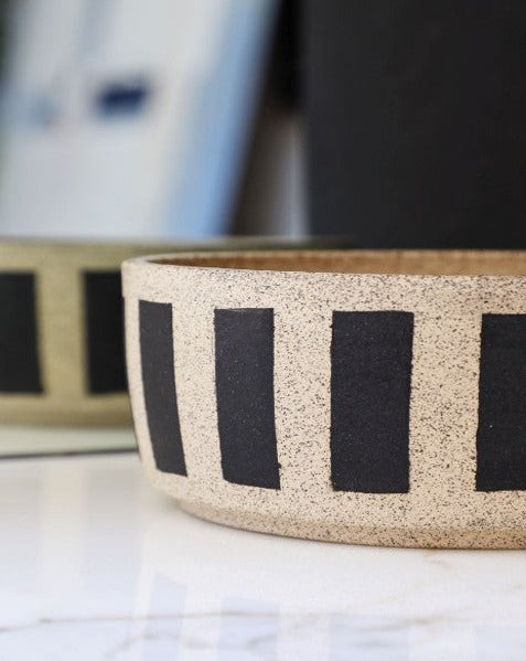 Each bowl is handmade with ceramic stonewear and striped, complete with a glaze to guarantee your pet eats and drinks safely. These bowls may vary in color and patinas, aging gracefully alongside your furry BFF.