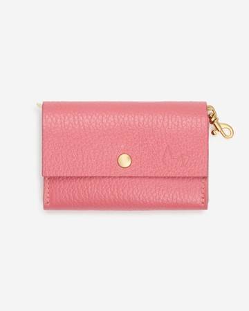 Stylish pink dog poop bag holder with gold hardware, ideal for chic walks with small breeds like Yorkies and Toy Poodles