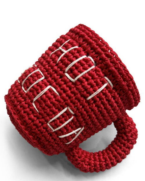 Holiday dog toy shaped like a mug of cocoa, soft crochet material.