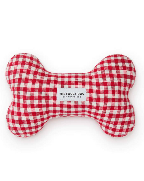 Red gingham plush dog toy shaped like a bone for playful pups.