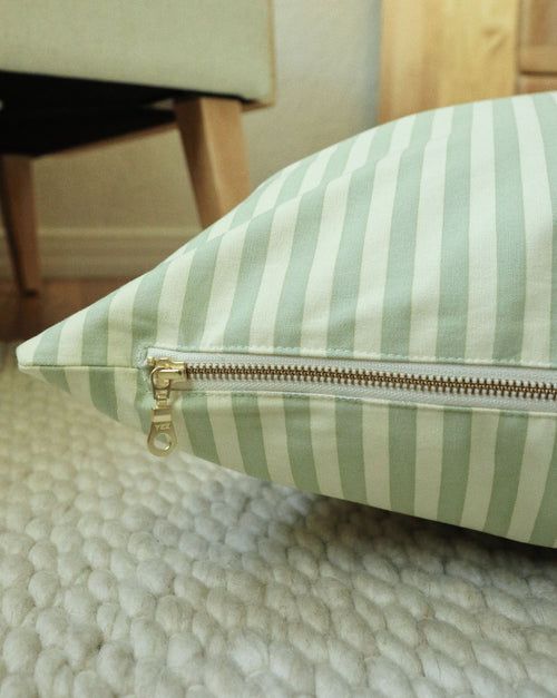 Top view of Capri green striped dog bed, highlighting cushioned interior and durable fabric.