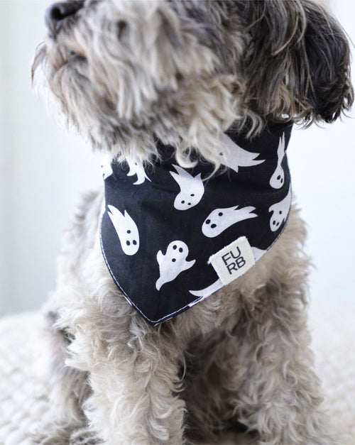 Angled view of ghost-themed dog bandana showing fabric texture and playful Halloween design