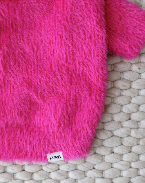 Fashion-forward hot pink dog sweater featuring playful eyelash knit details.