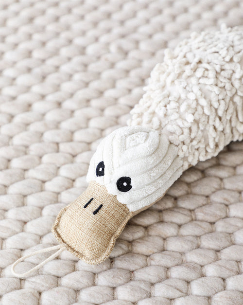 Cute platypus-shaped plush dog toy with soft brown and beige fabric.