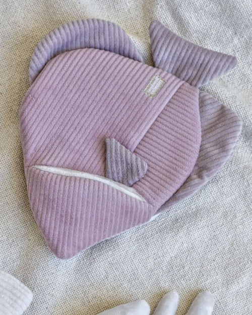 purple and pink corduroy fish dog toy on beige background