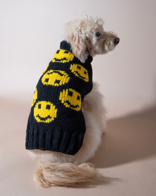 Smiley face black dog sweater for a cheerful pup.