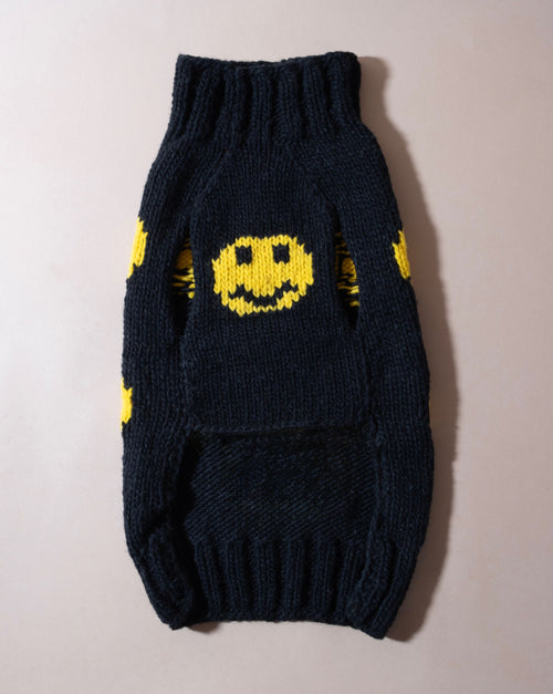 Black smiley face dog sweater, perfect for spreading joy at the park.