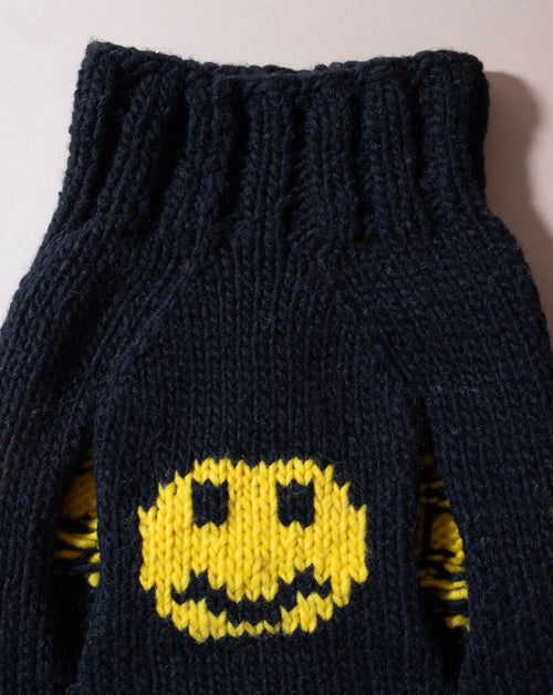 Smiley face dog sweater in black, ideal for playful pups.