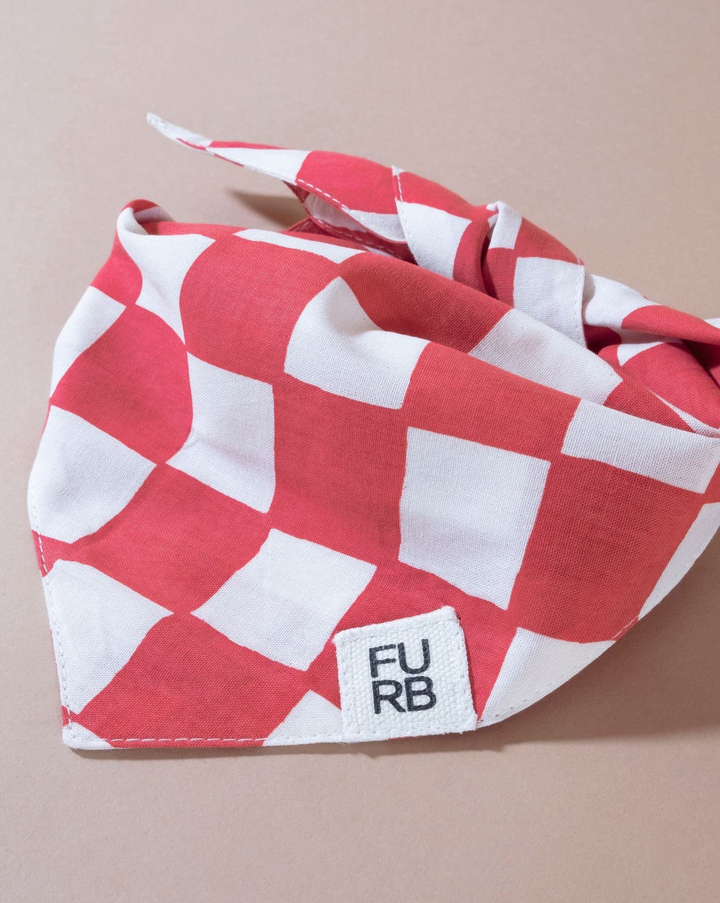 Trendy red checkered dog bandana, ideal for adding flair to your pet's look.