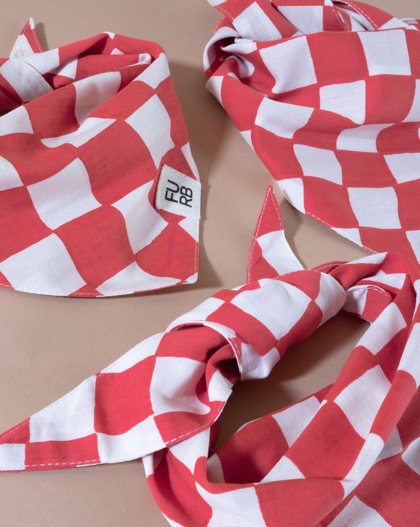 Red checkered bandana for dogs, offering a classic and chic accessory for your pup.