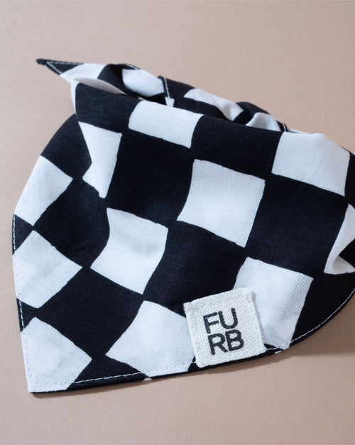 Stylish black and white checkered dog bandana for fashionable pets.