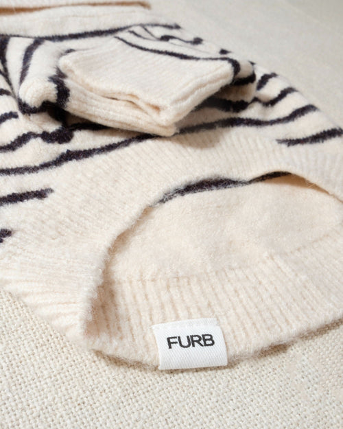 a striped dream, with a comfy ivory knit body covered in thin black stripes, and perfect ribbed ivory turtleneck with coordinating sleeves. The long turtleneck folds over as a toasty touch, and sleeves can be cuffed for a more casual vibe 