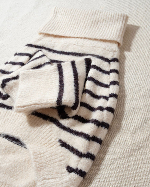 a striped dream, with a comfy ivory knit body covered in thin black stripes, and perfect ribbed ivory turtleneck with coordinating sleeves. The long turtleneck folds over as a toasty touch, and sleeves can be cuffed for a more casual vibe 