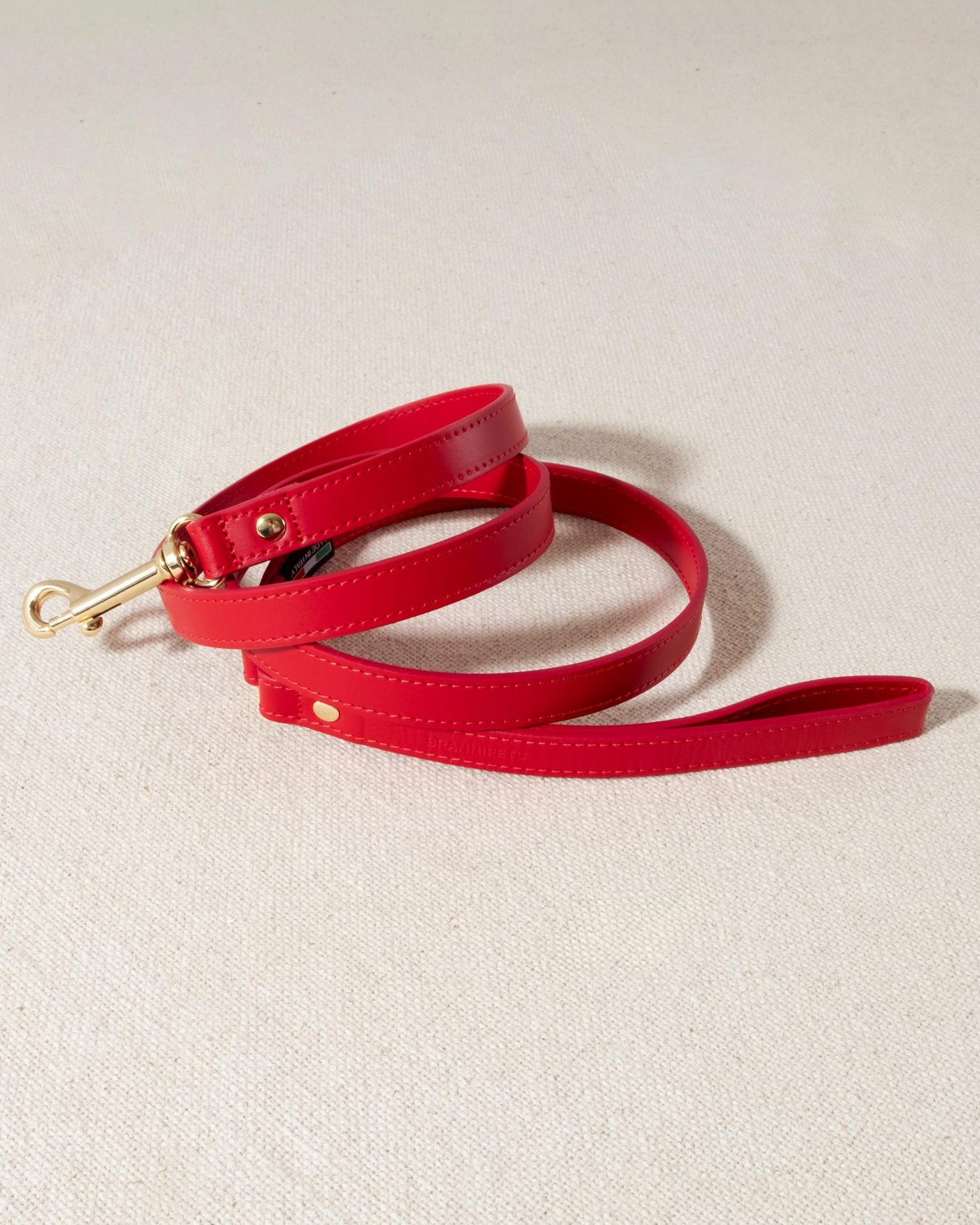red leather dog leash with gold accents