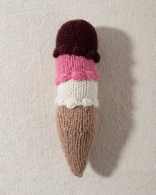 Hand-knit crochet ice cream dog toy with three scoops in brown, pink, and white, perfect for playtime fun.