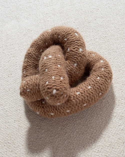 tan and white hand knit crochet pretzel dog toy