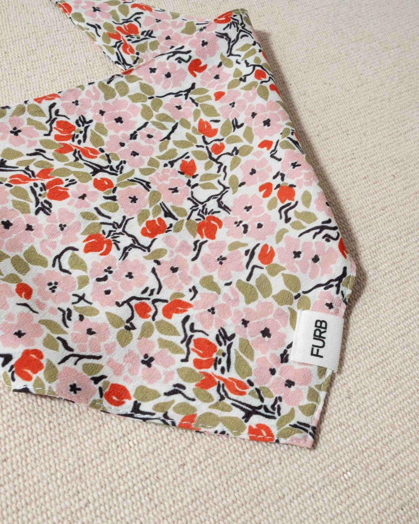 white and multi floral dog bandana and tasteful furb logo