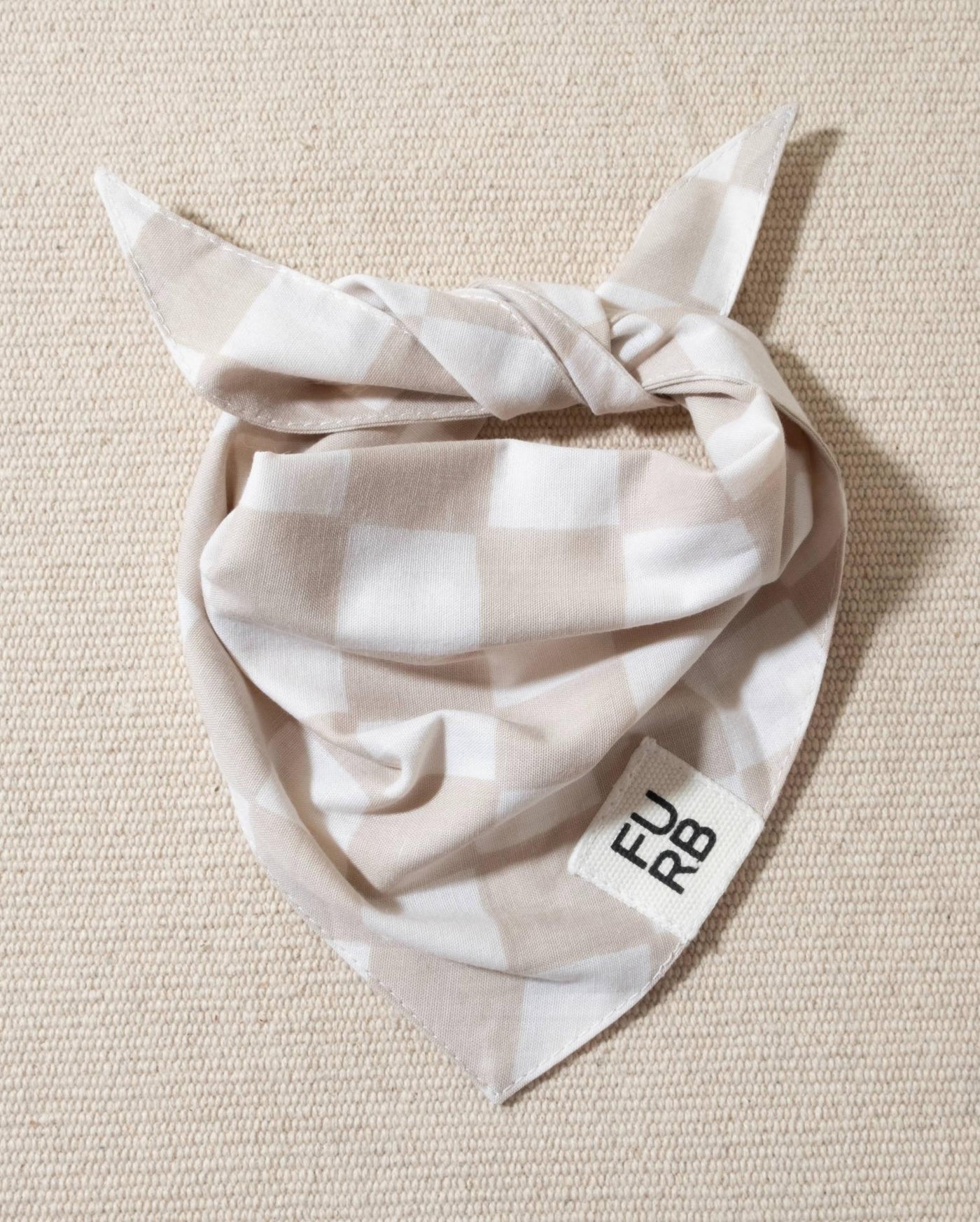 Light tan and white check dog bandana with tasteful Furb tag, perfect for casual outings.