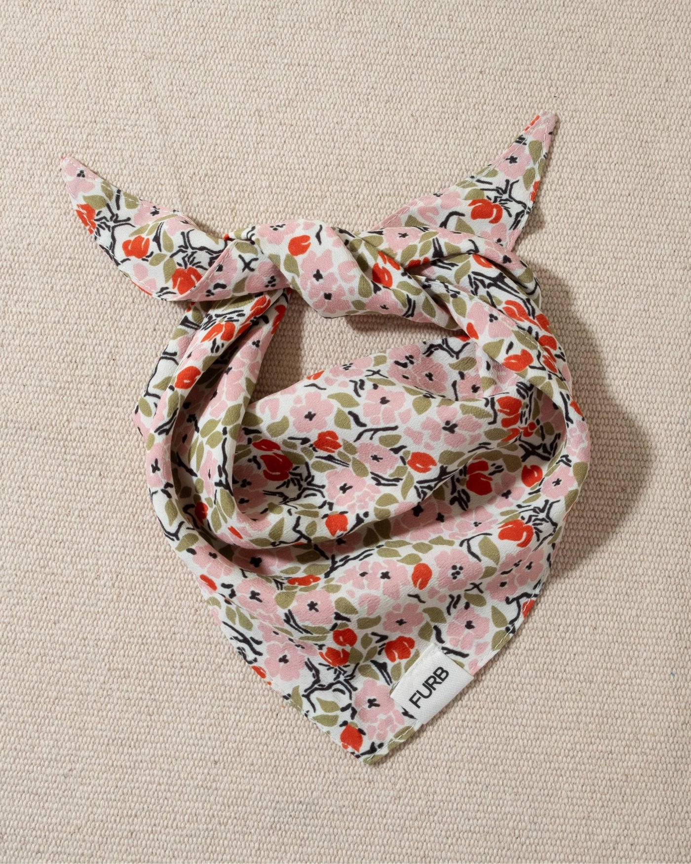 white and multi floral dog bandana and tasteful furb logo