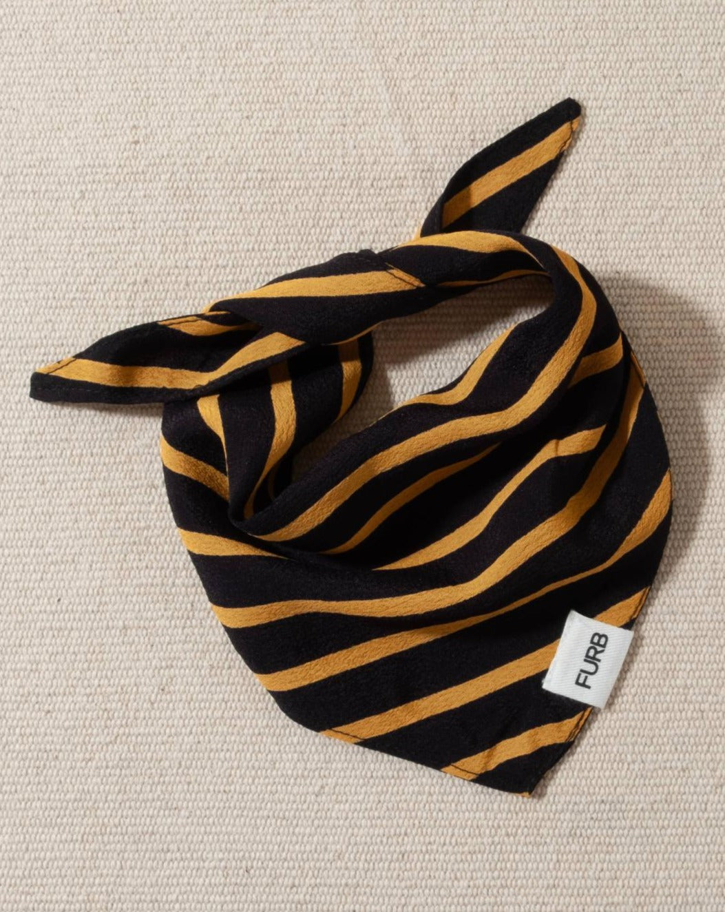 midnight blue dog bandana with yellow stripes and tasteful furb logo