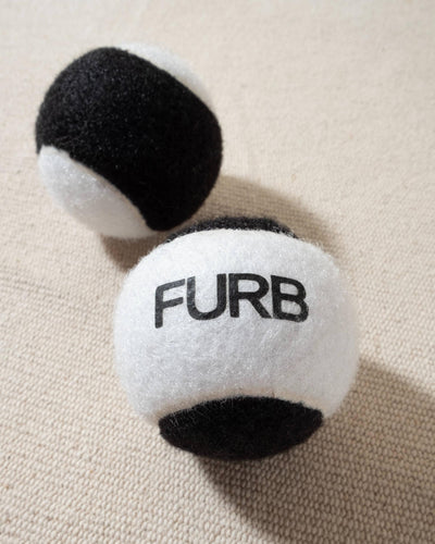 FURB branded black and white tennis ball with black furb logo for dogs