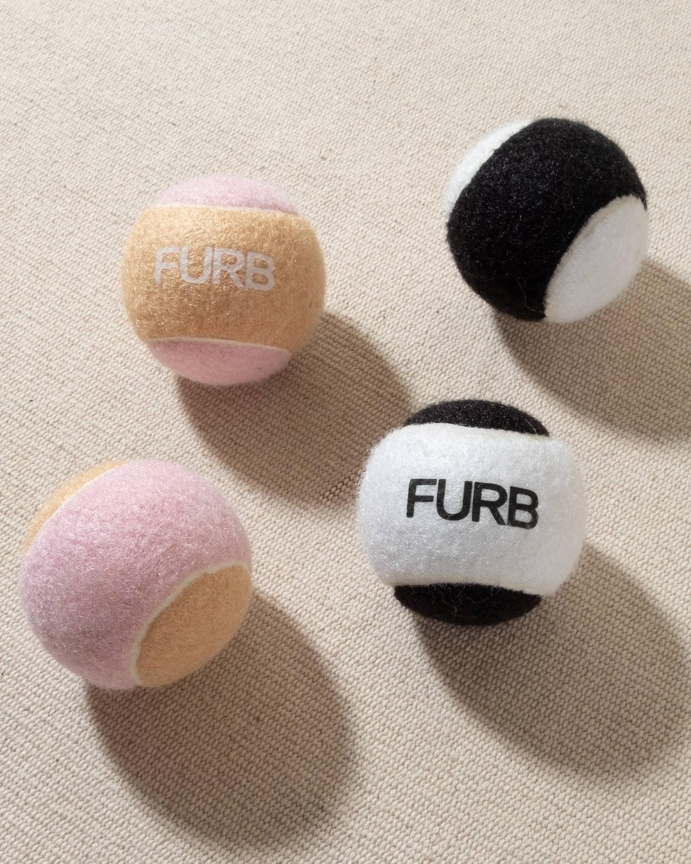 FURB branded black and white tennis ball with black furb logo for dogs