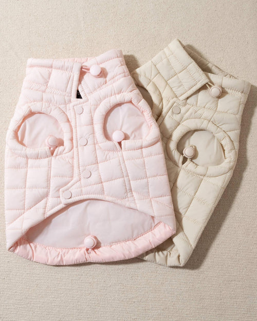 perfect on its own or layered with a cute sweater. This quilted, stylish jacket is fully adjustable, with coordinating light pink cords on the hem, neck, and arm openings. Jacket can be worn over harness, with a small opening for leash attachment on the back. Asymmetrical buttons also make for more secure wear, for even the most portly of pups!. Beagle pink jacket.