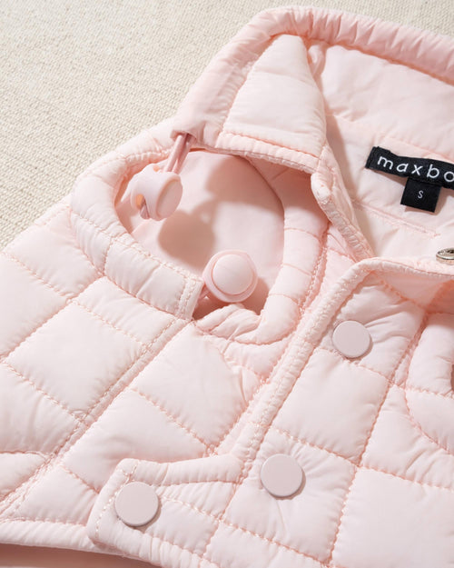 perfect on its own or layered with a cute sweater. This quilted, stylish jacket is fully adjustable, with coordinating light pink cords on the hem, neck, and arm openings. Jacket can be worn over harness, with a small opening for leash attachment on the back. Asymmetrical buttons also make for more secure wear, for even the most portly of pups!. Frenchie pink jacket.