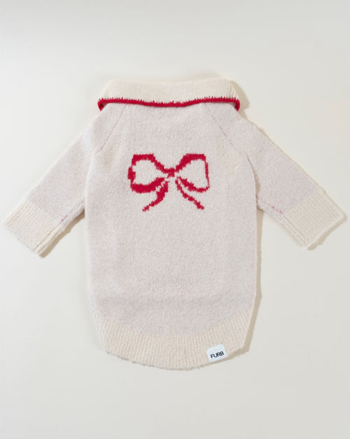 Elegant ivory dog sweater with a large bow, perfect for special occasions.