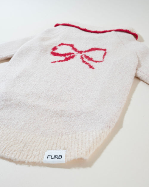 Stylish ivory bow dog sweater, perfect for dressing up your furry friend.