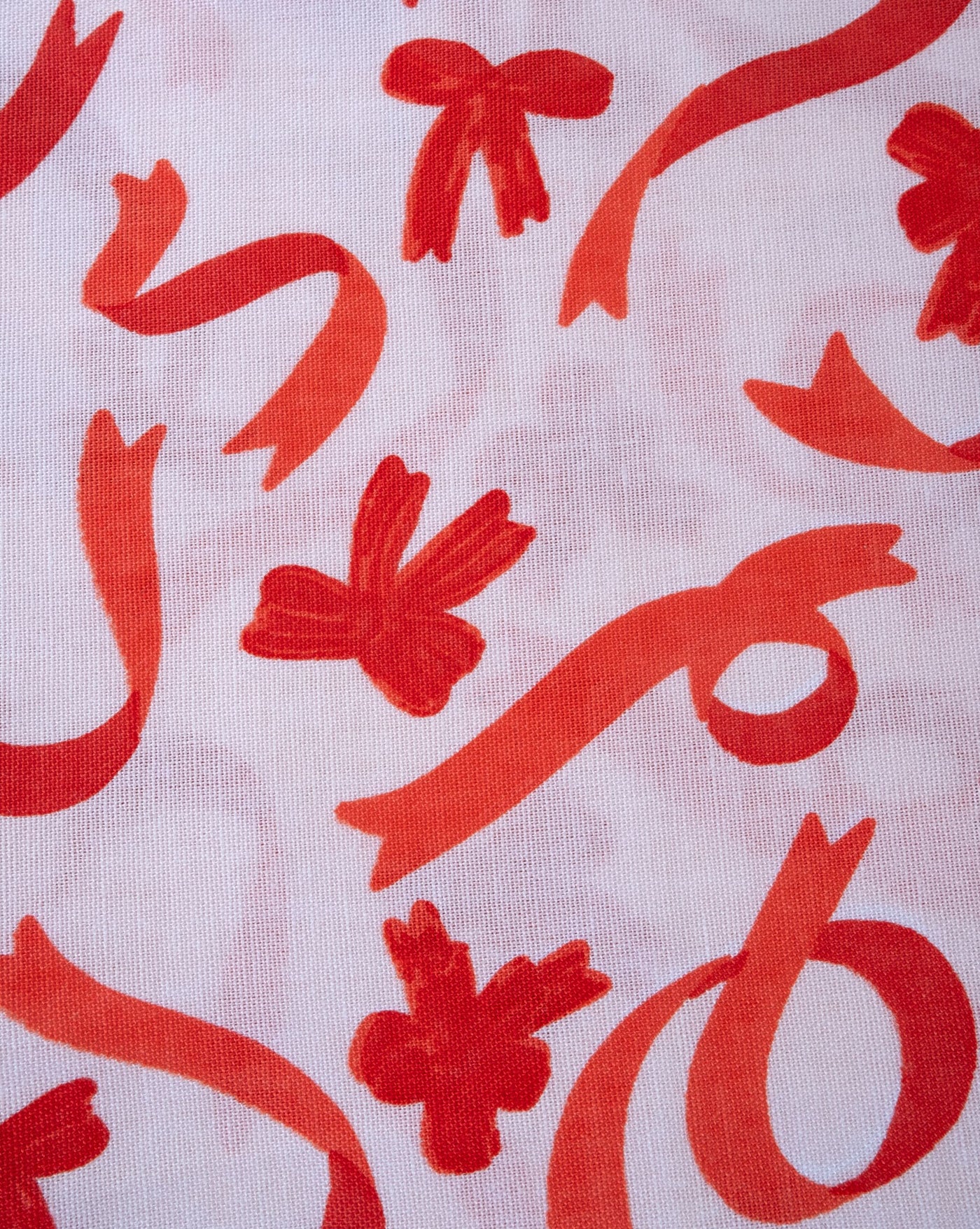 Bow print dog bandana for the holiday season, adding festive cheer to your pup’s wardrobe.