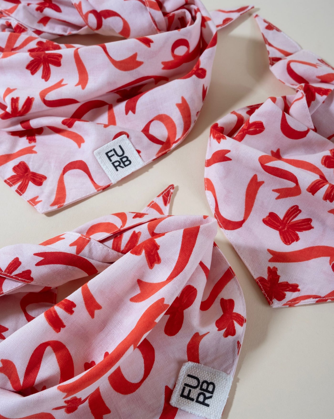 Holiday bow print dog bandana, great for celebrating the season in style.