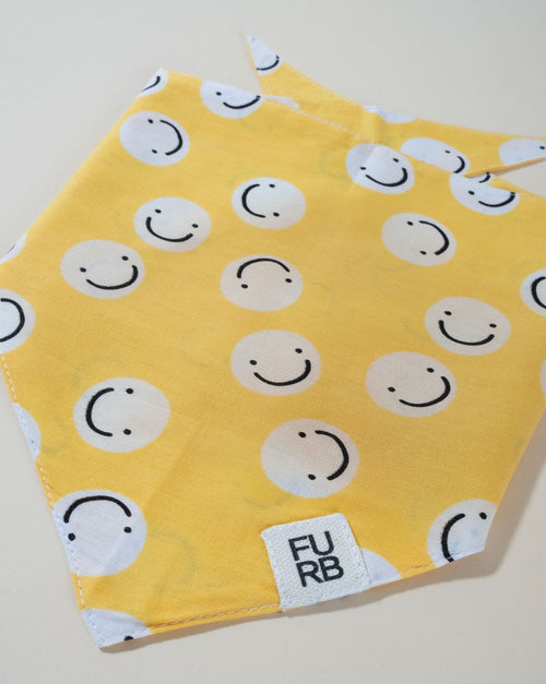 Yellow smiley face dog bandana, designed to spread smiles wherever your pup goes.